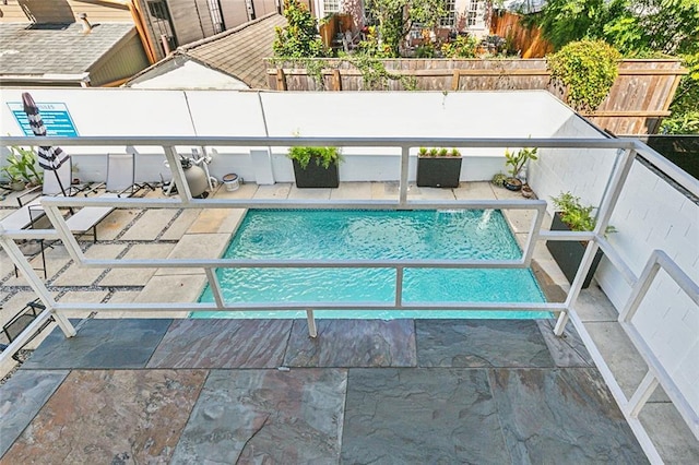 view of swimming pool with a patio area