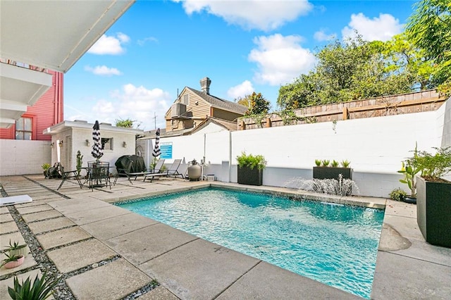 view of swimming pool with a patio area