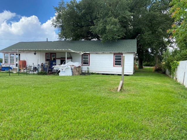 back of house featuring a yard