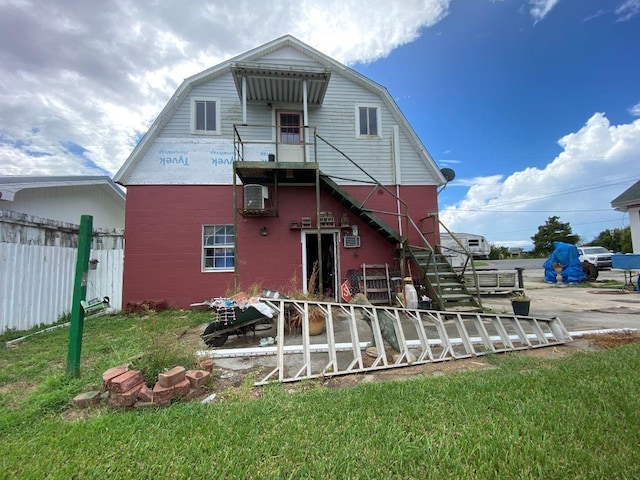 rear view of property with a lawn