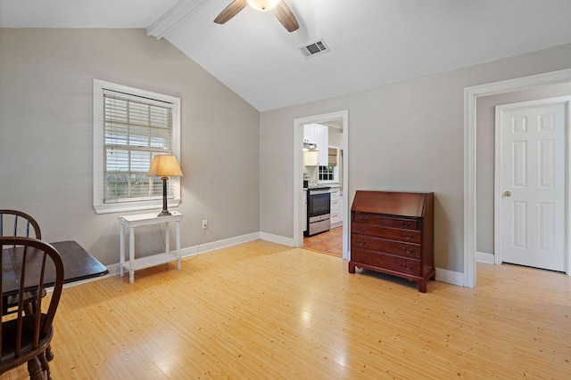 living area featuring lofted ceiling with beams, light wood-type flooring, and ceiling fan