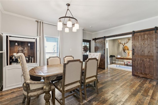 dining area with crown molding, dark hardwood / wood-style floors, and a barn door