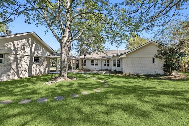 back of house with a lawn