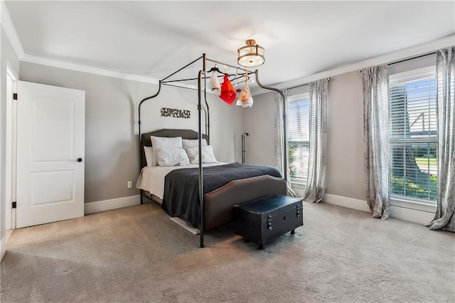 bedroom featuring ornamental molding, multiple windows, and carpet floors