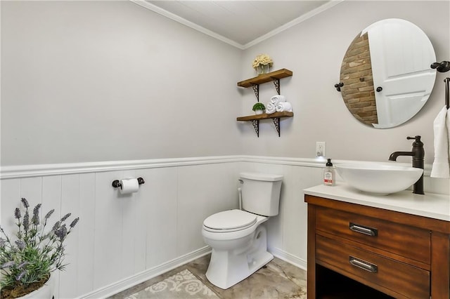 bathroom with toilet, crown molding, and vanity