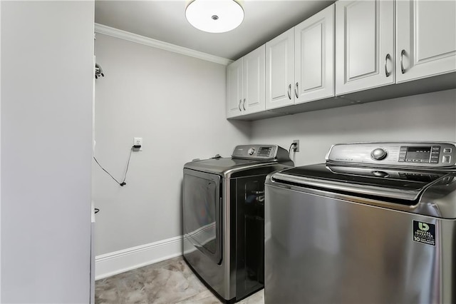 washroom with cabinets, crown molding, and separate washer and dryer