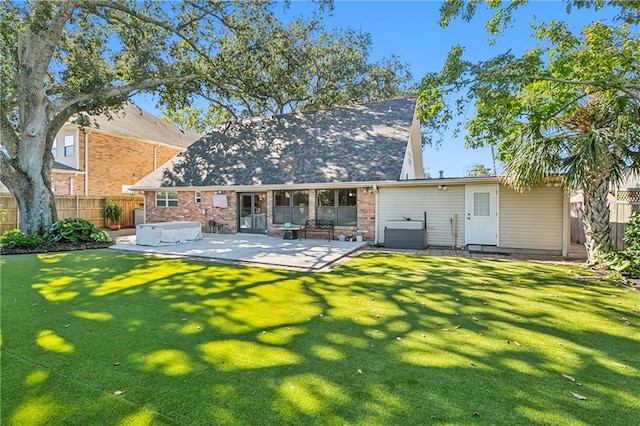 back of house featuring a patio and a yard