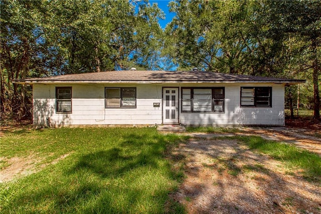 ranch-style home with a front lawn