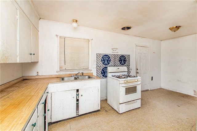 kitchen with white cabinetry, sink, and white range with gas stovetop