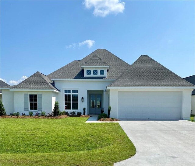 prairie-style house with a garage, french doors, roof with shingles, and stucco siding