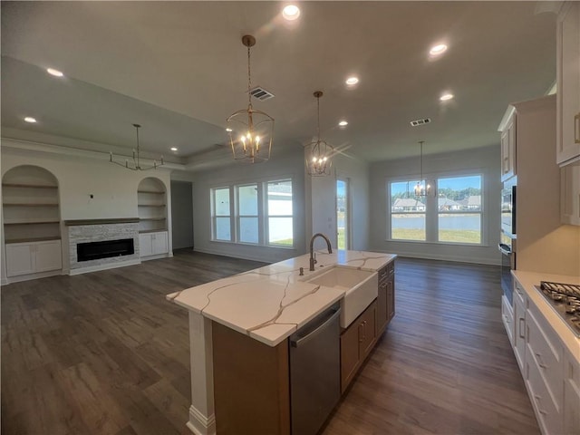 kitchen with a spacious island, pendant lighting, white cabinetry, appliances with stainless steel finishes, and a water view