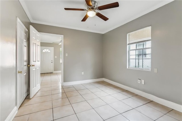 tiled empty room featuring crown molding and ceiling fan