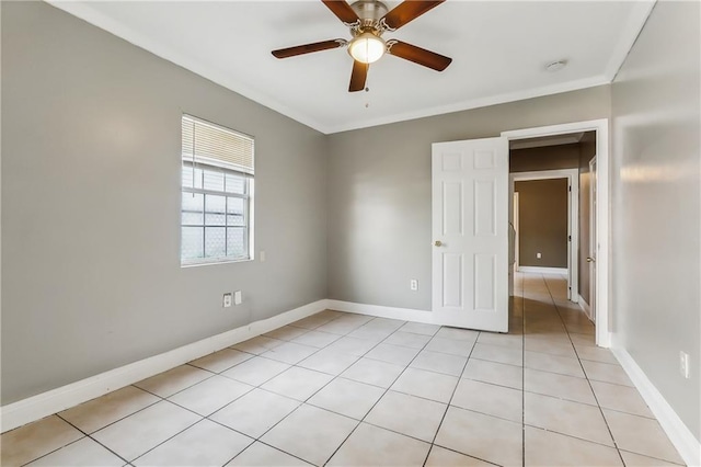 unfurnished room featuring crown molding, light tile patterned floors, and ceiling fan