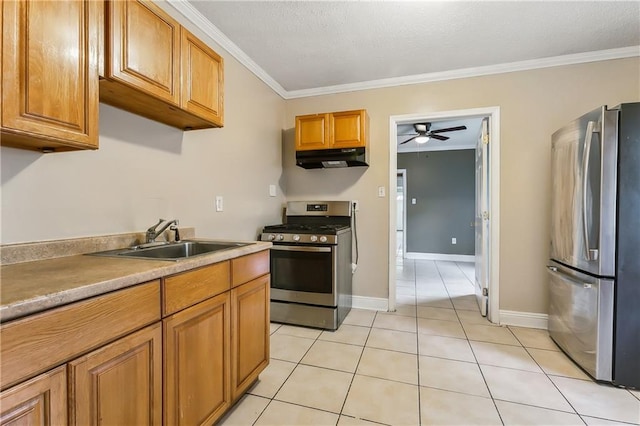 kitchen with sink, ceiling fan, stainless steel appliances, ornamental molding, and light tile patterned floors