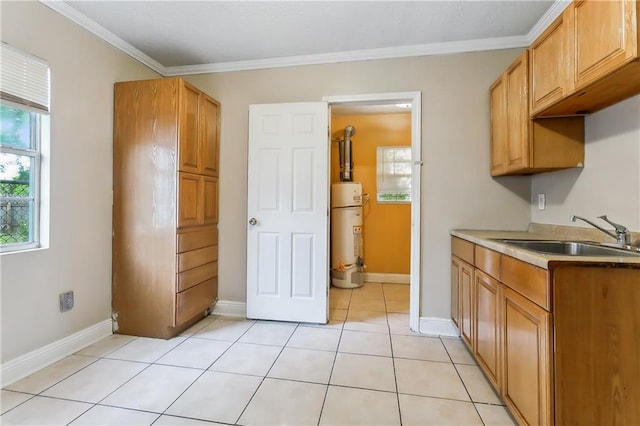 kitchen featuring gas water heater, ornamental molding, sink, and light tile patterned floors