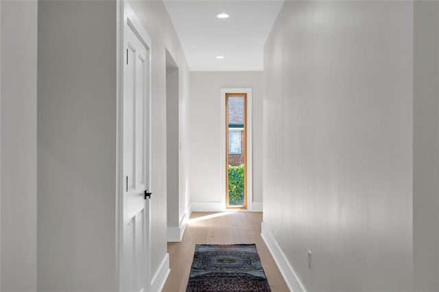 hallway with light hardwood / wood-style floors