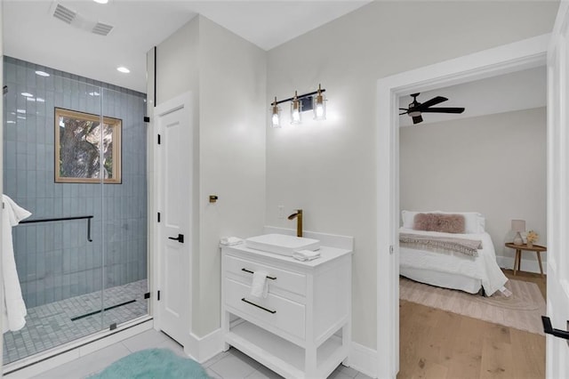 bathroom featuring vanity, ceiling fan, wood-type flooring, and a shower with door