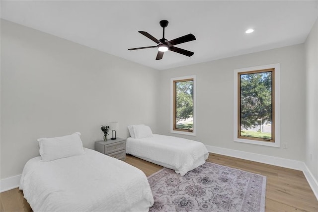 bedroom featuring ceiling fan and light hardwood / wood-style flooring