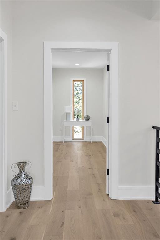 corridor with light hardwood / wood-style floors