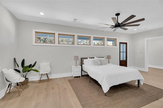 bedroom with light hardwood / wood-style floors and ceiling fan