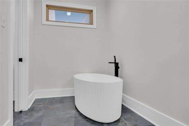 bathroom with concrete flooring