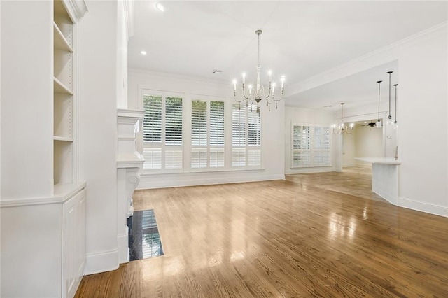 unfurnished living room featuring ornamental molding, a chandelier, and wood-type flooring