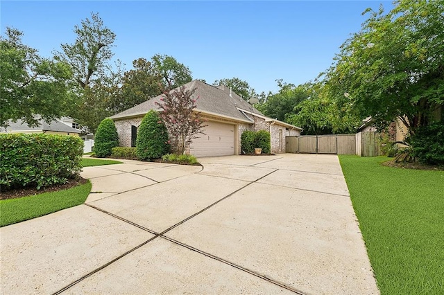 view of side of home featuring a yard and a garage