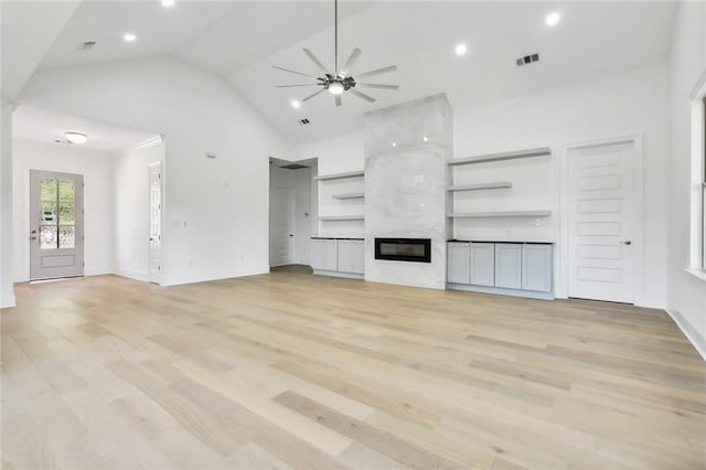 unfurnished living room with light hardwood / wood-style floors, a fireplace, and ceiling fan