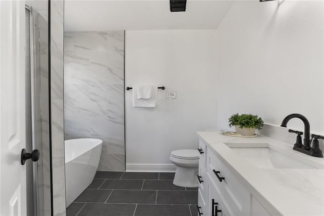 bathroom with vanity, toilet, a tub, and tile patterned flooring