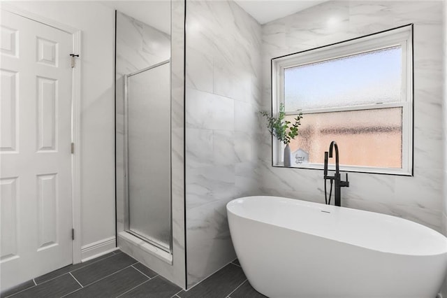 bathroom with tile walls, plus walk in shower, plenty of natural light, and tile patterned flooring