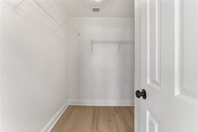 walk in closet featuring hardwood / wood-style flooring