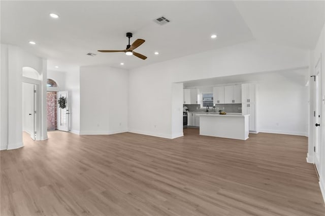 unfurnished living room featuring light wood-type flooring and ceiling fan