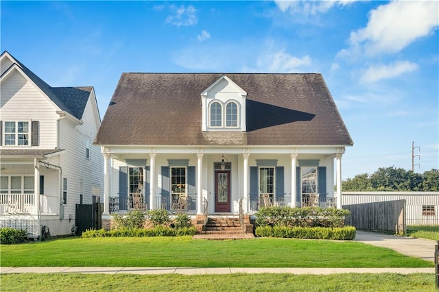 view of front facade featuring a front lawn and covered porch