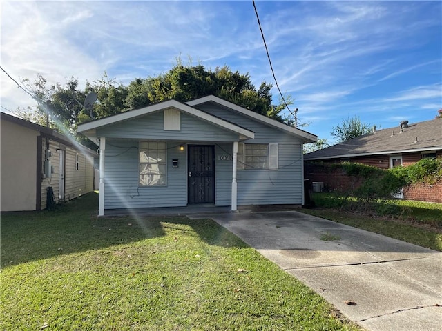 bungalow-style home featuring a front yard and a carport