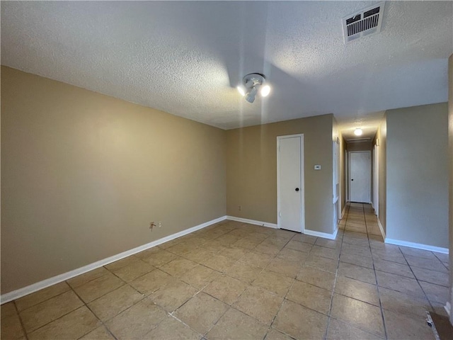 1023 Hendee St, New Orleans, LA 70114 - unfurnished room featuring a textured ceiling, attic access, light tile patterned floors, baseboards, and visible vents
