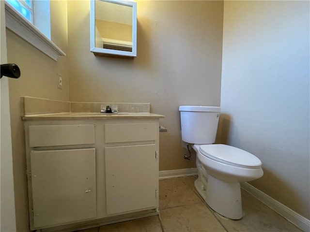 1023 Hendee St, New Orleans, LA 70114 - bathroom featuring vanity, toilet, baseboards, and tile patterned floors