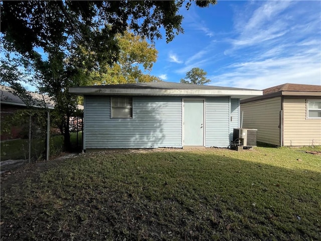 view of outbuilding featuring a yard and cooling unit