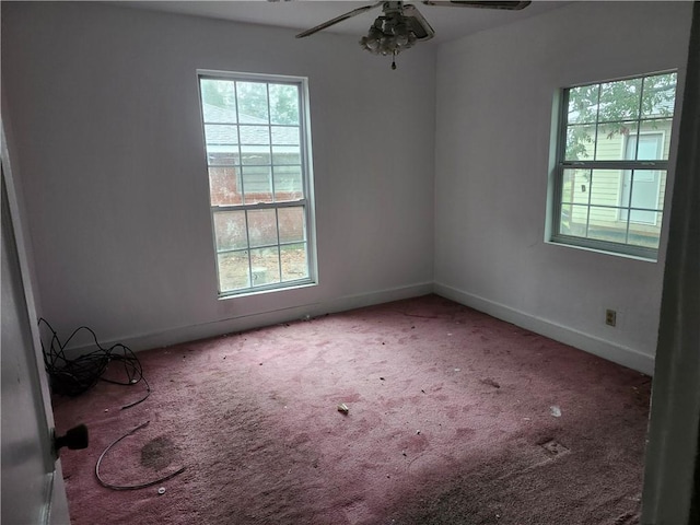 empty room with ceiling fan and carpet