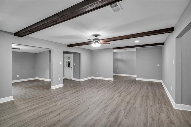 interior space featuring beam ceiling, light wood-type flooring, and ceiling fan