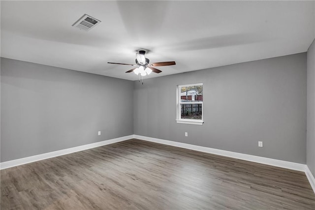 empty room featuring ceiling fan and dark hardwood / wood-style floors