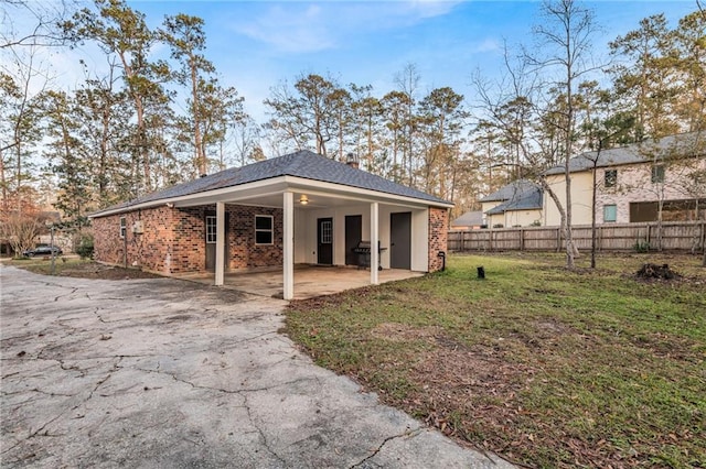 rear view of property featuring a yard