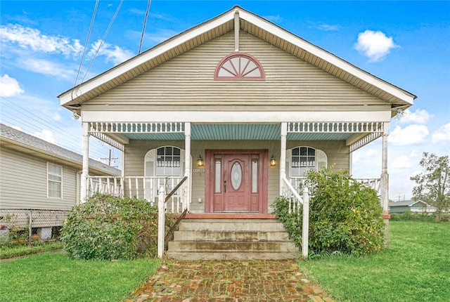 bungalow with a front lawn and a porch