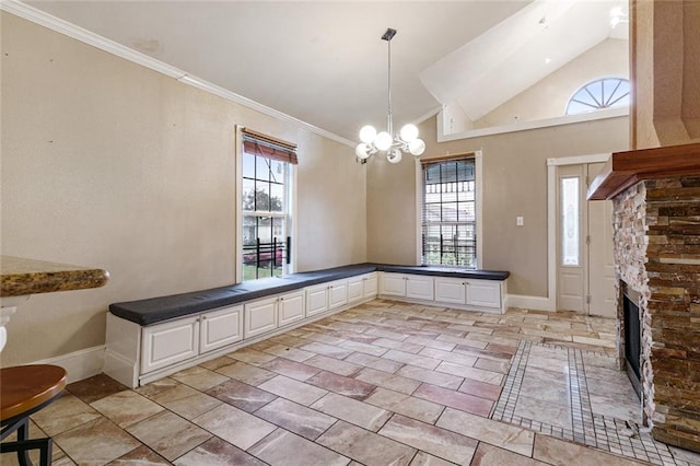 unfurnished dining area with a fireplace, plenty of natural light, and ornamental molding