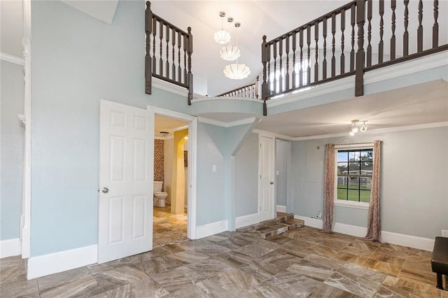 interior space with crown molding and a towering ceiling