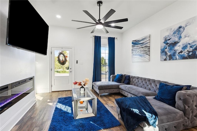 living room featuring ceiling fan and dark hardwood / wood-style flooring