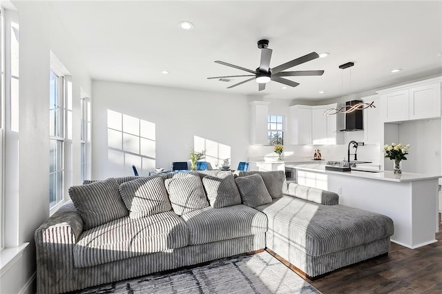 living room featuring sink, ceiling fan, dark hardwood / wood-style flooring, and plenty of natural light