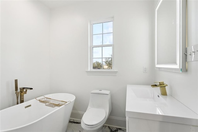 bathroom featuring vanity, toilet, and a washtub