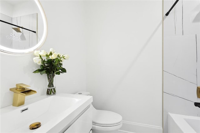 full bathroom featuring vanity, tiled shower / bath, and toilet