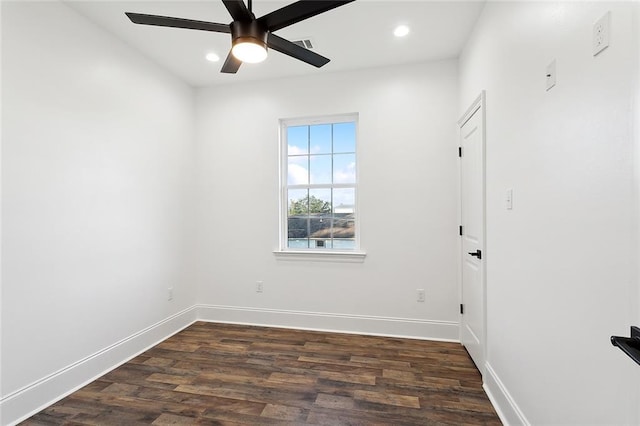 spare room featuring dark wood-type flooring and ceiling fan