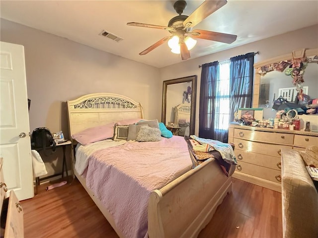 bedroom with hardwood / wood-style floors and ceiling fan